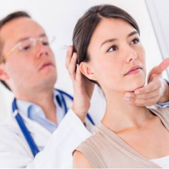 The neurologist examines a patient with neck pain